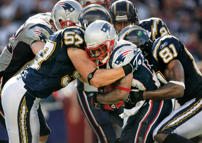 Patriots cornerback Ellis Hobbs is tackled after an interception against the San Diego Chargers
